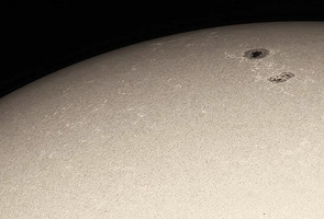 sun through a higher quality telescope with a white light filter